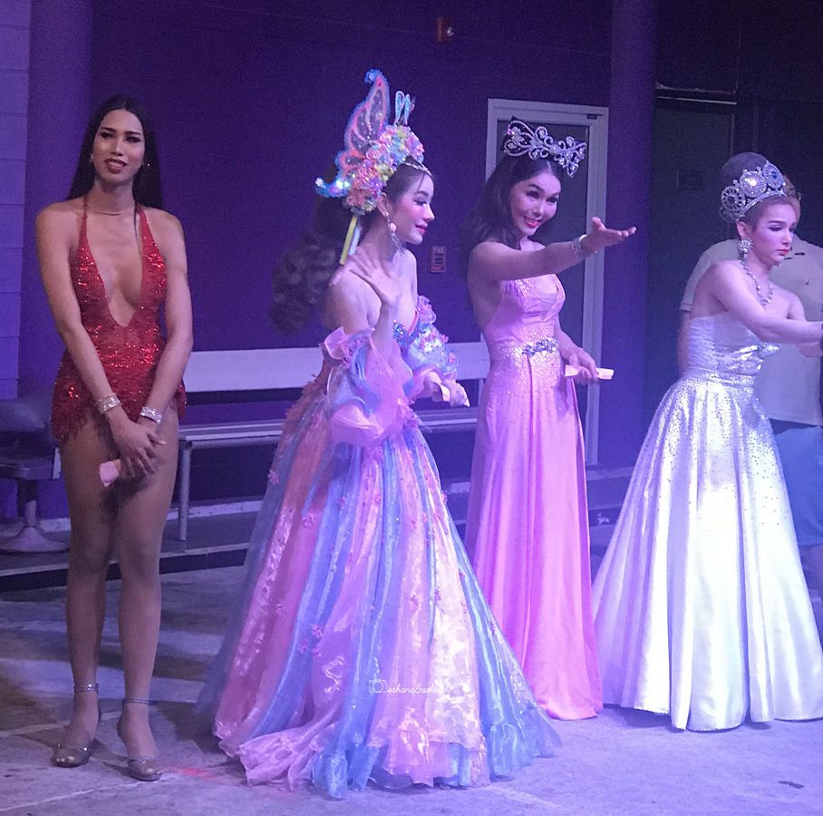 Four lady boys wearing colourful and revealing costumes inviting customers at Simon Cabaret show in Phuket