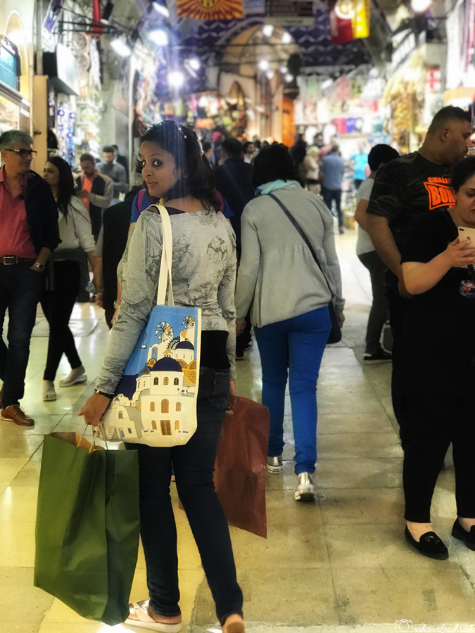 Indian woman travel blogger holding shopping bags at Istanbul grand bazar