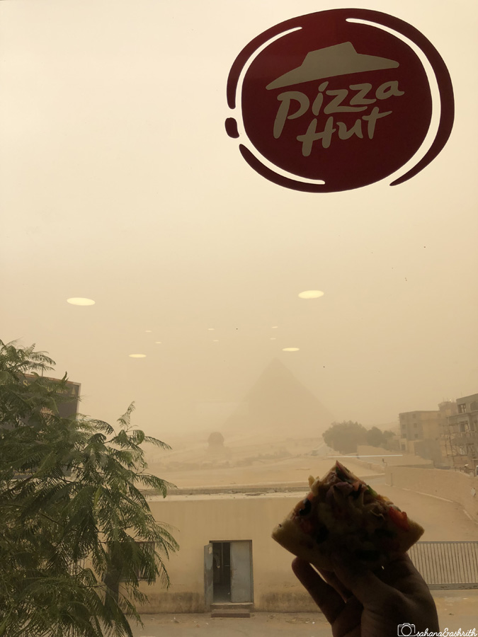 Blurred view of Giza pyramids from Pizzahut