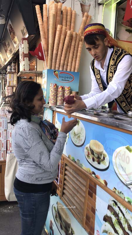 Turkish man doing his dondurma ice cream tricks on an indian traveller