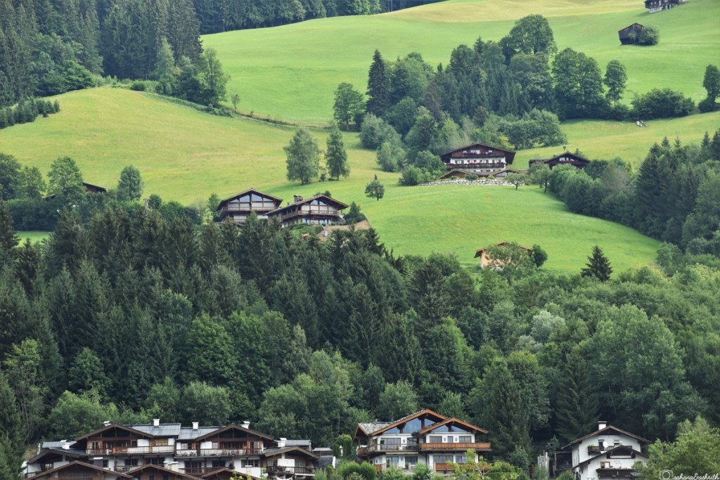 Beautiful Austrian grassland on mountains with traditional tyrolean homes