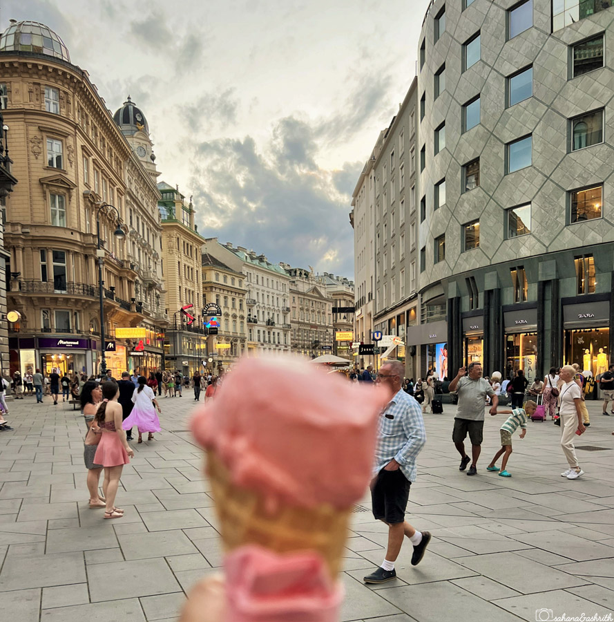 strawberry icream in the busy stephenplatz of vienna full of historical buildings