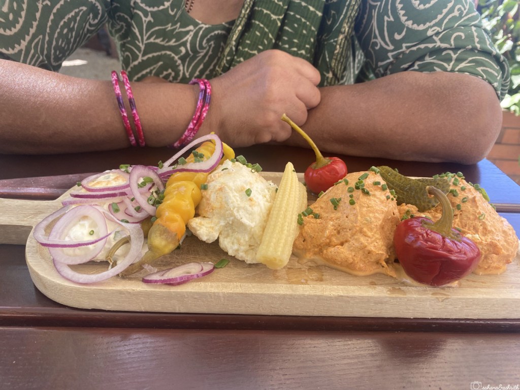 typical vegetarian food in austria  with onion slices with steamed corn and cream on a wooden plate kept on a table in Austria