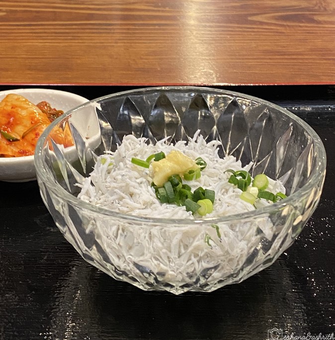traditional japan food with fish shavings topped with onion