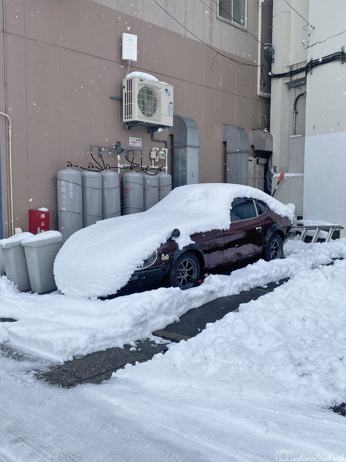 car parked in Japan covered with snow