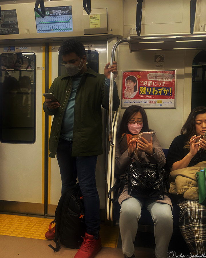 people in japan public transport watching their phones