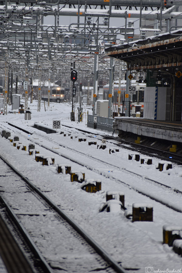 japan's main public transport train on tracks during snowfall