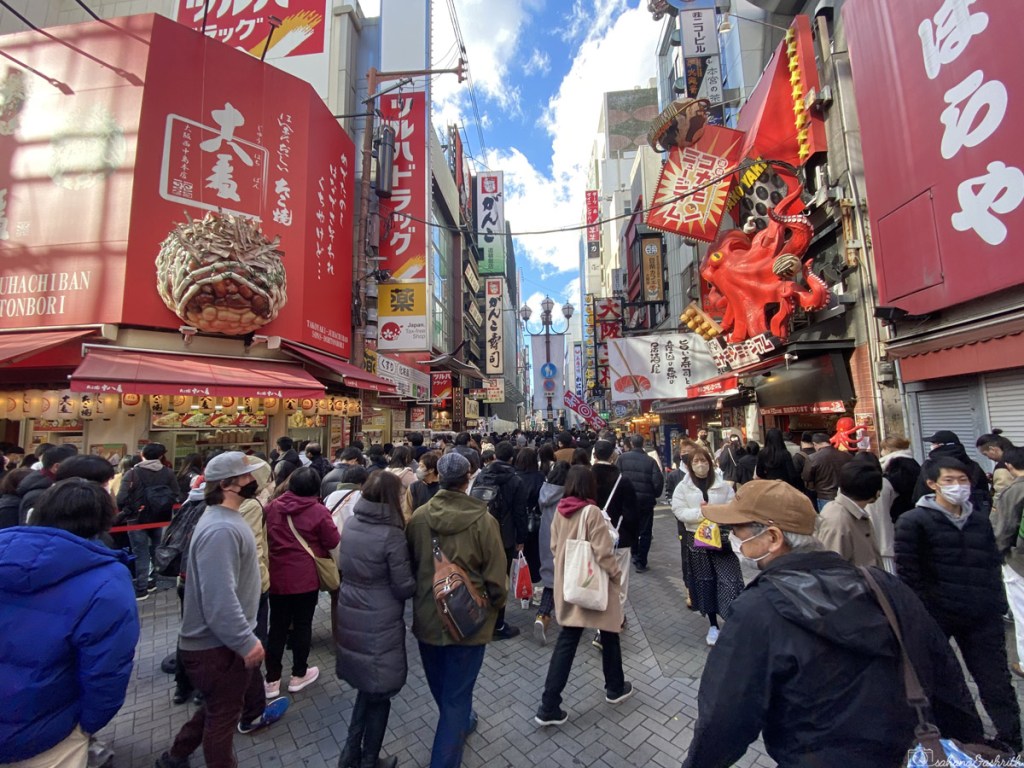 busy food street in Japan's Osaka with crowd