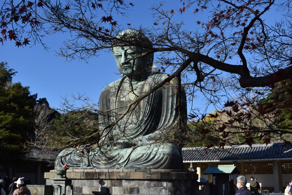 13 metres tall buddha statue in meditating pose at Kamakura on a sunny day during day trip from tokyo