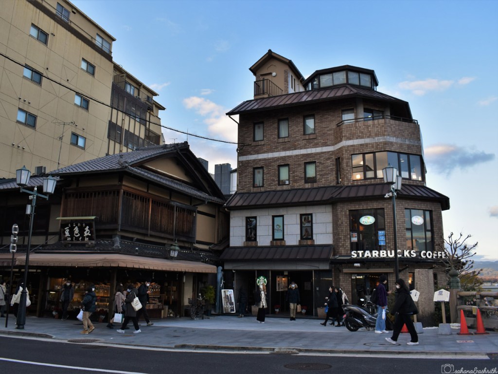 starbucks building beside a traditional Japanese home at Kyoto in Japan