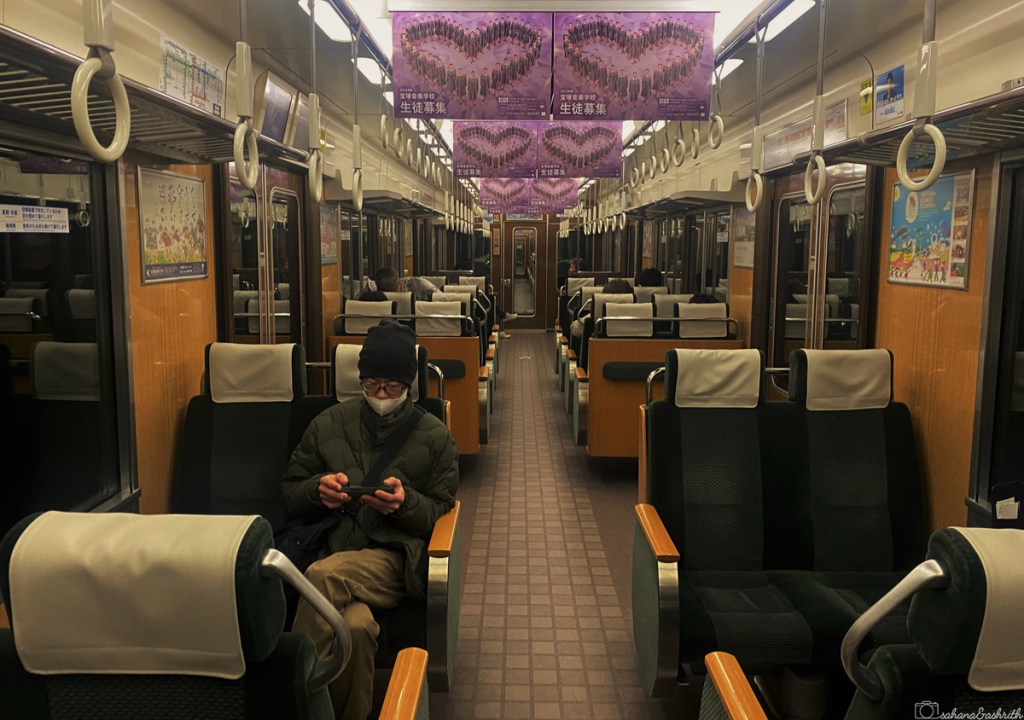picture depicting a fascinating fact about Japan where a Japanese man sitting quietly in the train