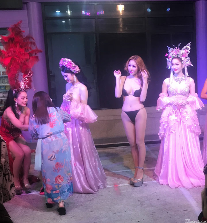 lady boy wearing black bikini standing beside four other ladyboy cabaret performers