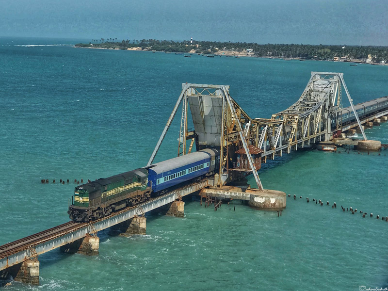 train crossing the Pamban Bridge in Rameshwaram, above the turquoise waters of the Indian Ocean in Tamil Nadu, South India