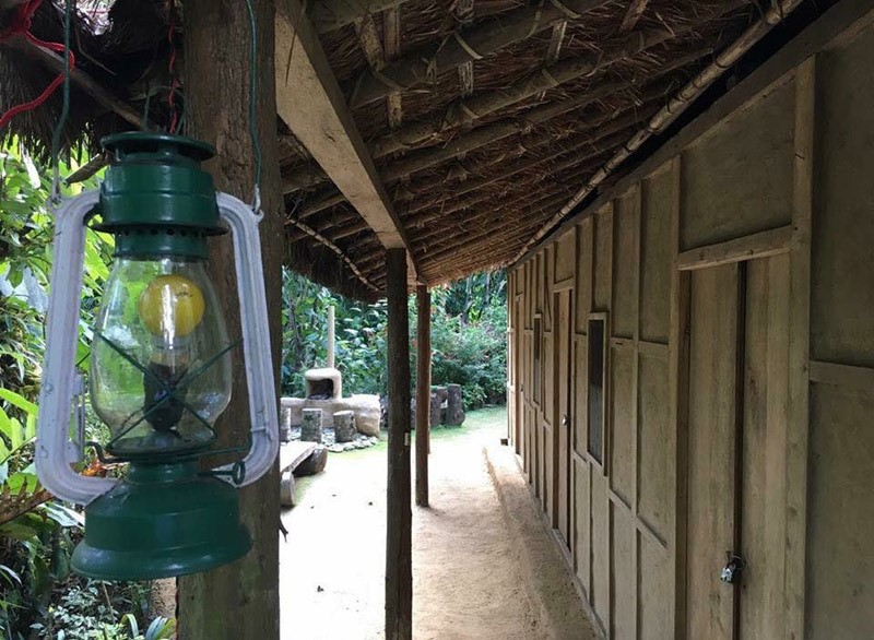 A lantern hanging in the front yard of a homestay constructed with mud and wood in Kalimpong, West Bengal, India