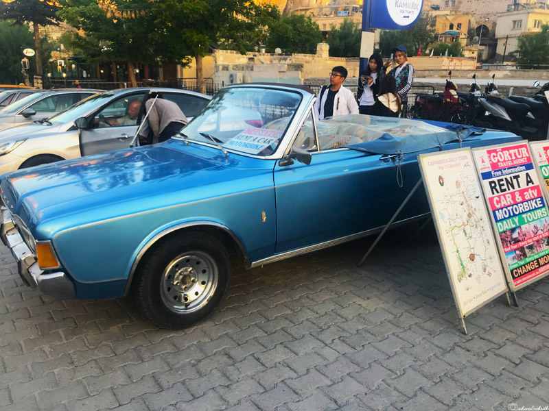turkey travel guide showing a blue vintage car with top open for rent in cappadocia