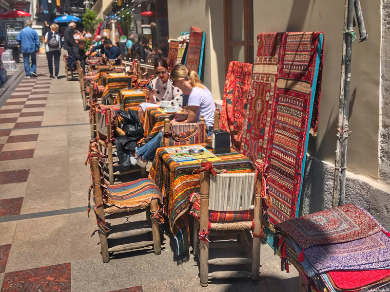 streetside cafe with seats cladded with turkish carpets