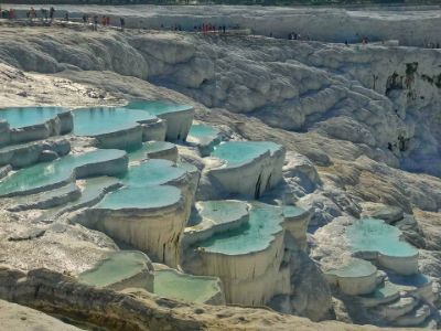 turquoise water in white travertine pools across many levels in Pamukkale