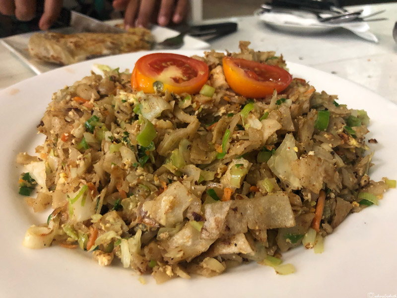 kuthu paratha with tomato slice on top
