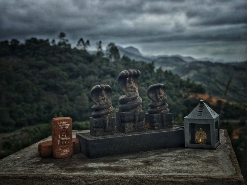 Stone idols of Naga placed along the hillsides in Kodaikanal, India.