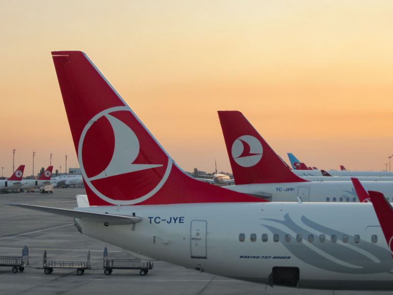 turkish airlines Boeings parked in airport during sunset