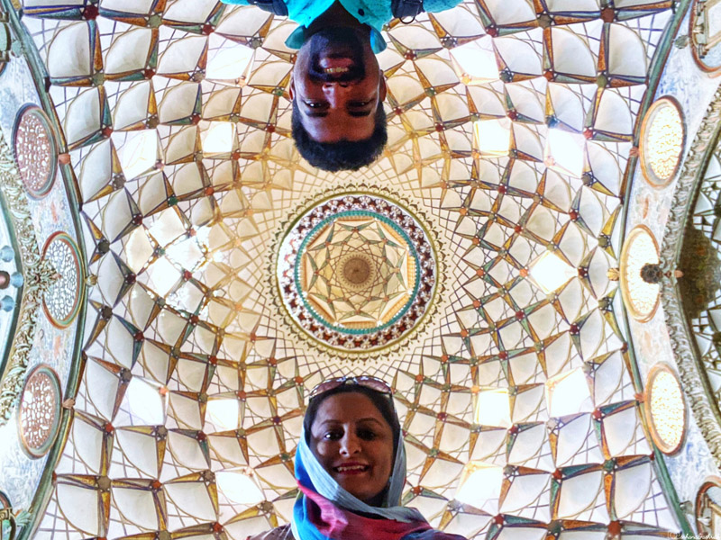 indian couple selfie featuring heavily ornate ceiling in a mansion of kashan