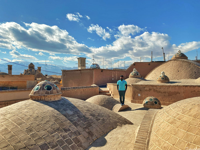 indian tourist at the terrace of bath house in kashan