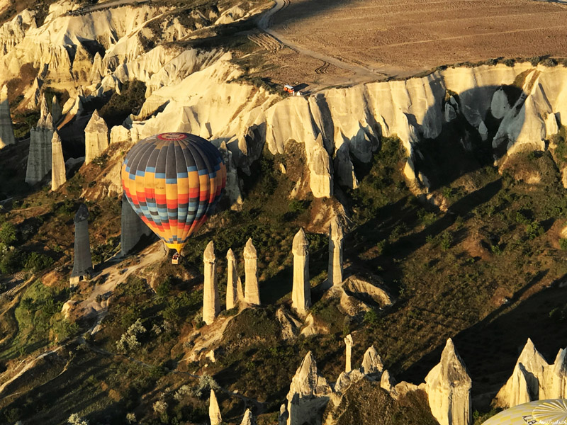 colourful hot air balloon above penis like lime formations in cappadocia