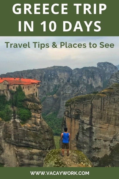 vacaywork author ashrith standing on the edge of a massive stone cliff, gazing at a monastery on the opposite side, with tall rocks and green mountains surrounding the scene in meteora on a cloudy afternoon