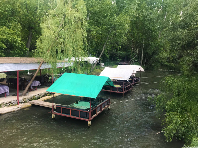 huts on water as seating for dining at ihlara