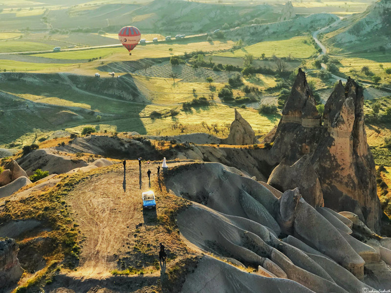 aerial view of pre-wedding photoshoot on the hills of cappadocia overlooking green valley