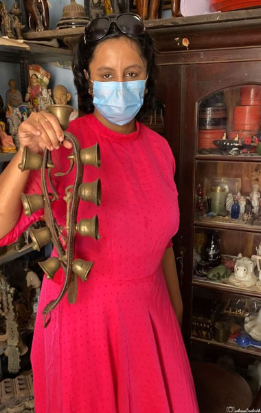vacaywork author sahana holding cow belt with small bells at karaikudi market
