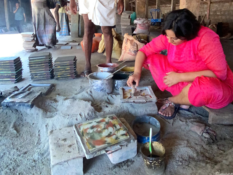 vacaywork author sahana making athangudi tile sitting on mud floor