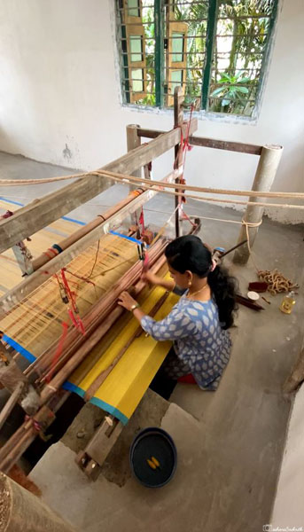 woman sitting on floor weaving chettinad saree