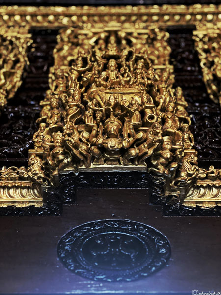 heavily detailed carvings of sculptures on door entry way in a chettinad mansion