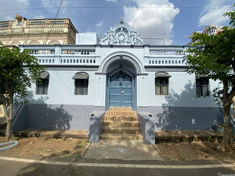 french blue painted face of traditional yet small chettinad house beside the road