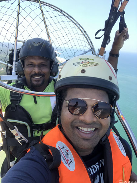 vacaywork author ashrith shetty up in the air while paramotoring taking selfie with pilot at bentota