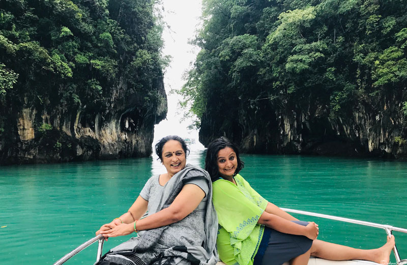 vacaywork author sahana with her mothing sitting on a boat in an island
