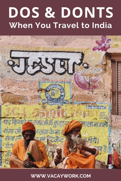 pinterest image showing two indian saints wearing saffron robe and long beard sitting on the ghats of varanasi