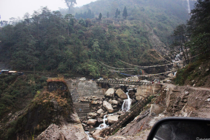 A military camp with green tents nestled in a rugged, mountainous terrain on the way to North Sikkim