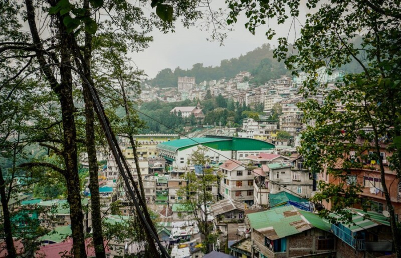 A vibrant view of the town of Gangtok in East Sikkim, with colourful houses and buildings nestled among lush green hills
