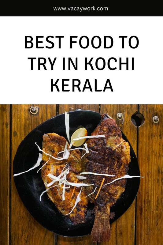 Close-up image of a plate with grilled fish garnished with lemon slices and shredded cabbage. Text on it says Best Food to Try in Kochi Kerala