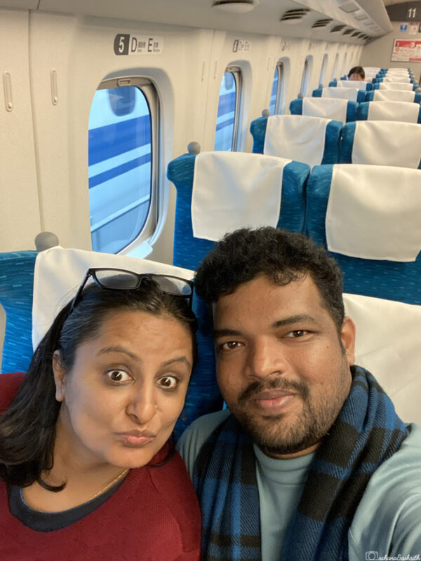 sahana and ashrith sitting inside japanese bullet train