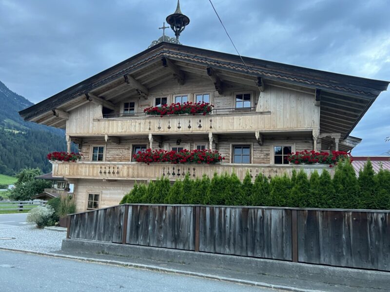 Typical Tyrolean wooden house with balcony flowers in Kirchberg, Tirol.