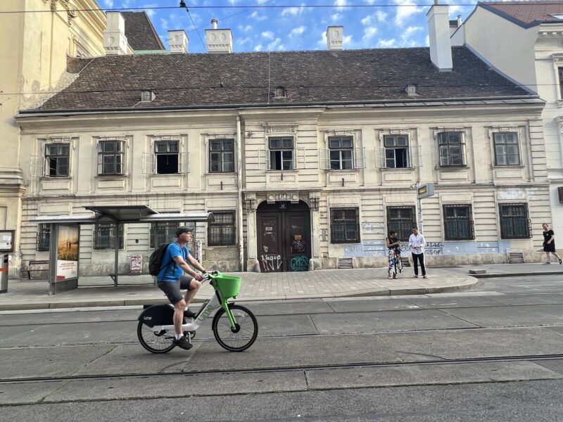 A local man cycling in a non-touristy area with simple houses near the Westbahn neighbourhood in Vienna