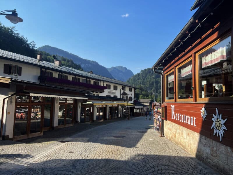 Peaceful morning on the shopping lane in Schönau am Königssee, lined with souvenir shops, cafés, and mountain views.