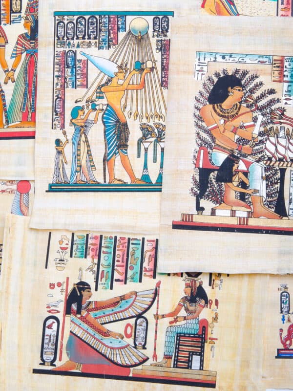a4 size papyrus papers with egyptian motifs painted and hung for sale on a wall in egyptian shop
