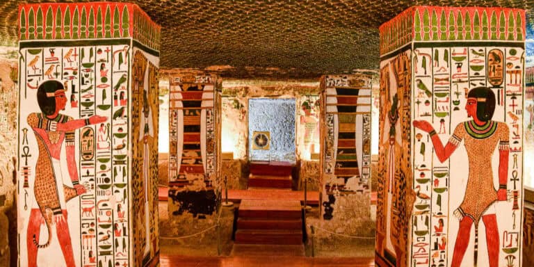 Painted tomb columns with hieroglyphs and figures inside the Valley of the Kings in Luxor, Egypt.