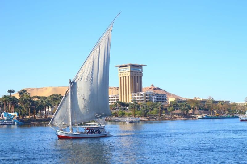 Traditional felucca sailing on the Nile River in Aswan, Egypt.