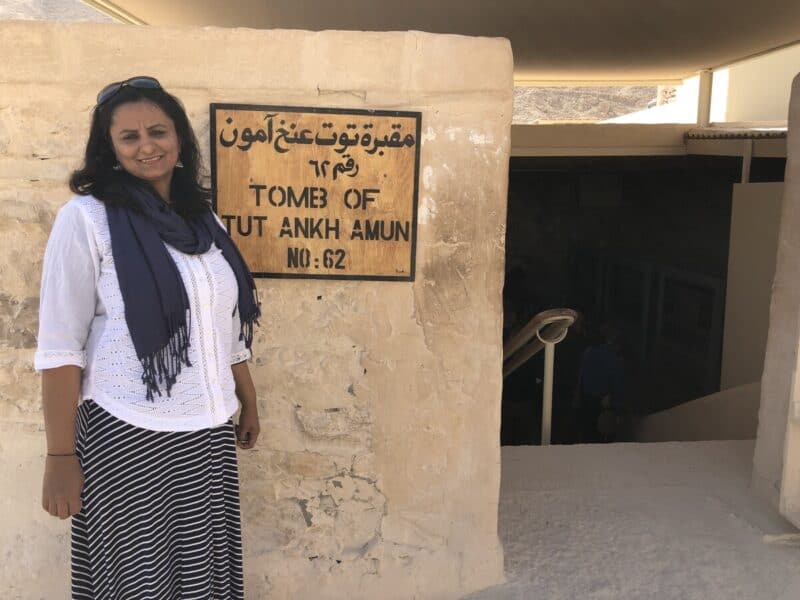 Traveller at the entrance of Tutankhamun’s tomb in Valley of the Kings, Luxor, Egypt.