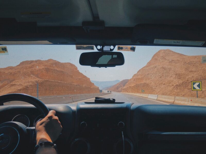 View from inside a car driving through desert mountains on the road in Egypt.